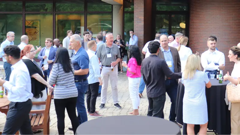 Attendees networking during summit's opening reception